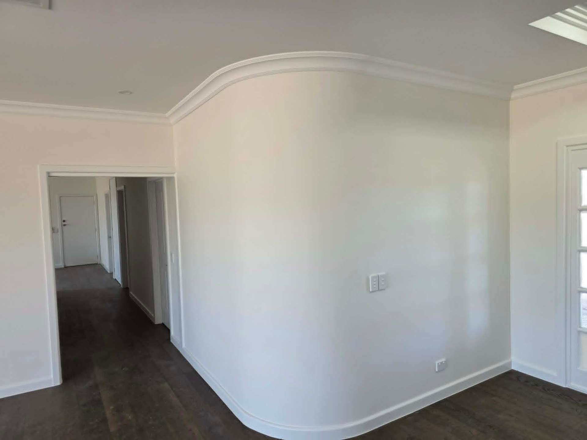 Curved plaster wall with square-set cornice in a Ballarat hallway