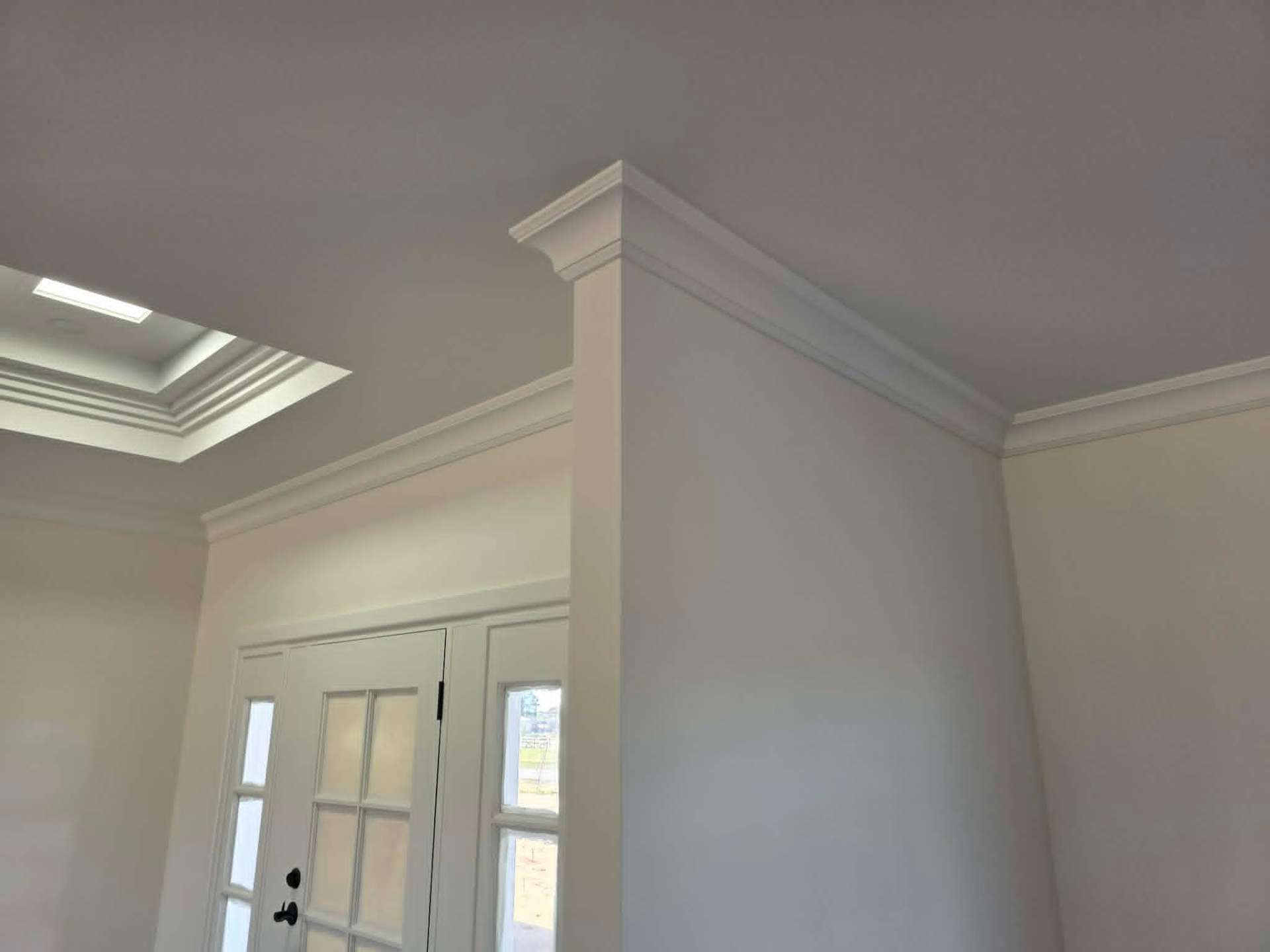 Ornamental cornice meeting a stepped ceiling bulkhead in a Ballarat entry