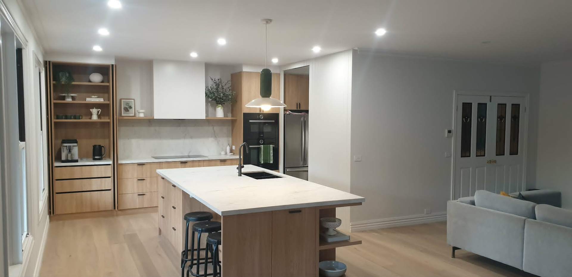 Modern kitchen and living space with flush plastered walls and ceilings in a Ballarat home